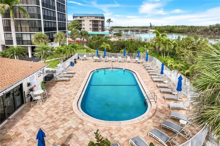 Community pool featuring a patio area and a water view