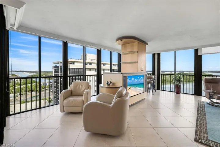 Sunroom / solarium with a water view and plenty of natural light