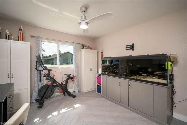 Workout room featuring light wood-type flooring and ceiling fan