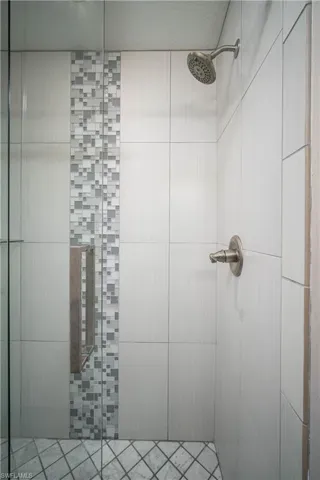 Bathroom featuring tile walls and a shower