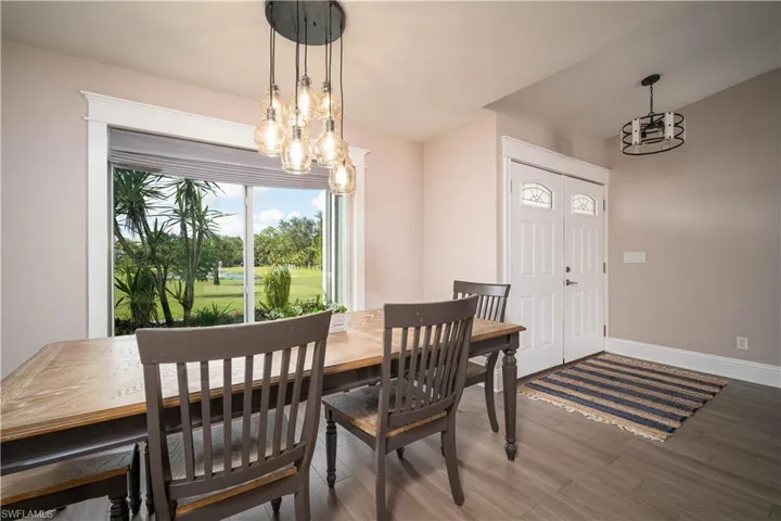 Dining room featuring wood-type flooring and a notable chandelier