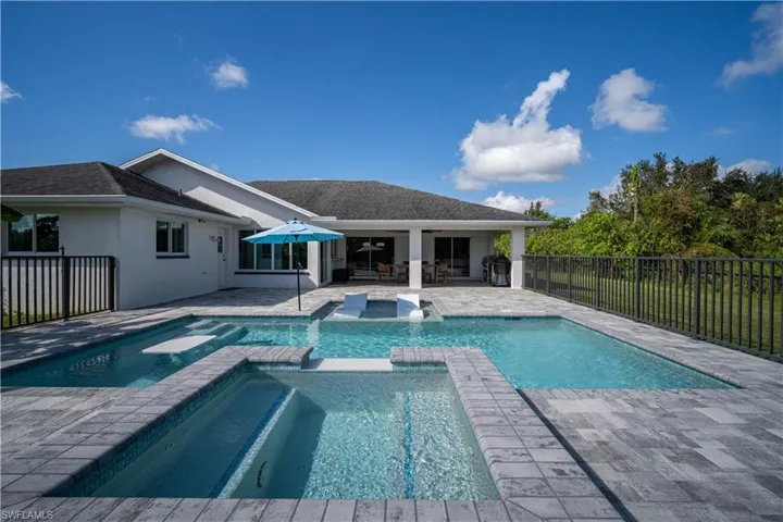 View of swimming pool featuring an in ground hot tub and a patio