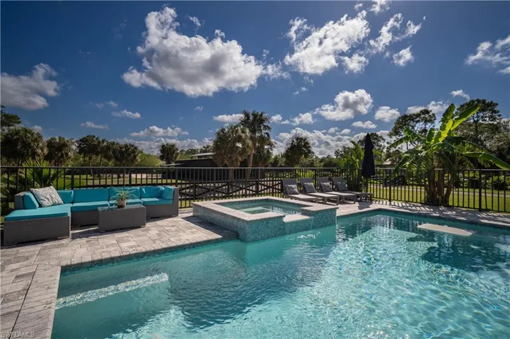 View of pool featuring an in ground hot tub, an outdoor hangout area, and a patio area
