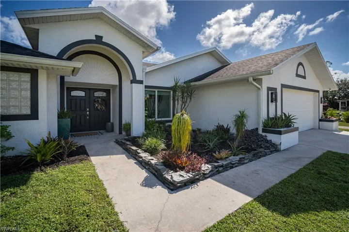 Doorway to property with a garage