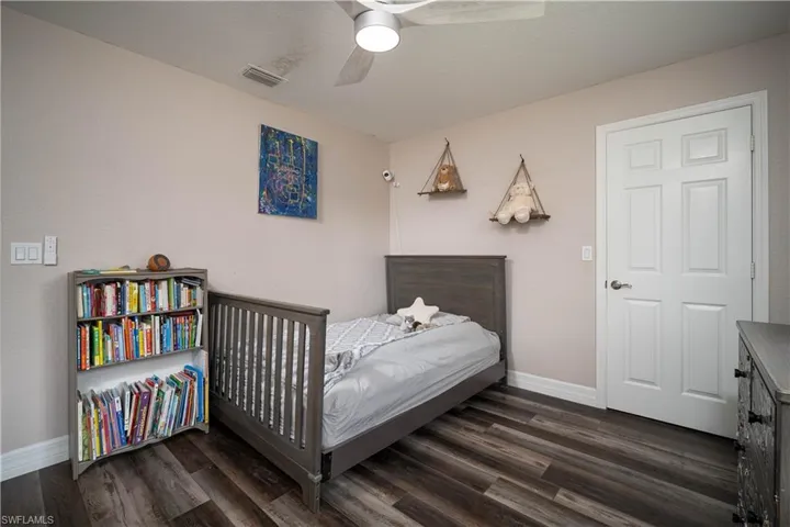 Bedroom featuring ceiling fan and dark hardwood / wood-style floors
