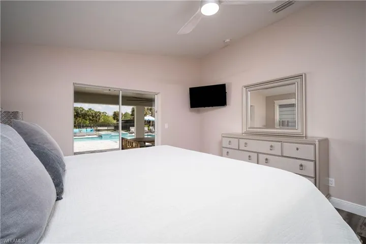 Bedroom with access to outside, ceiling fan, and wood-type flooring