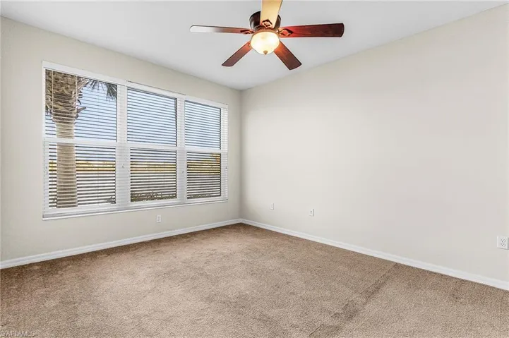 Spare room featuring ceiling fan and carpet floors