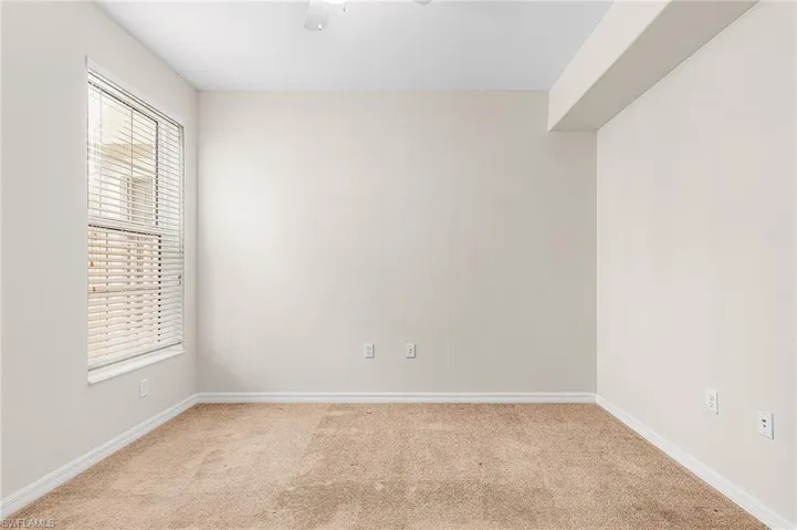Spare room featuring carpet flooring and a ceiling fan