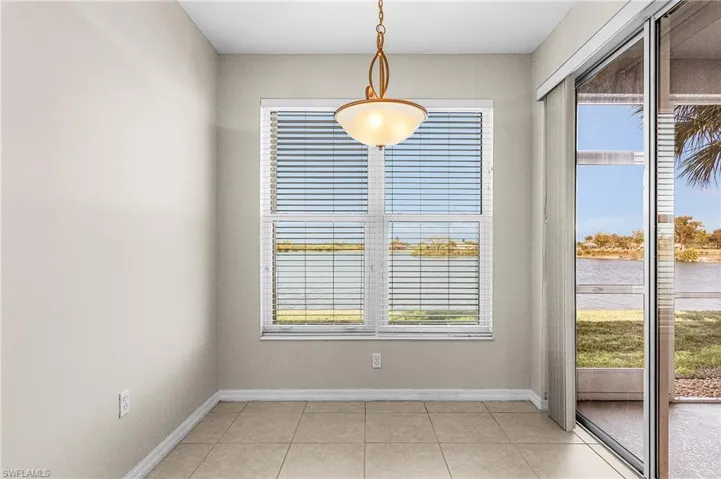 Unfurnished dining area featuring a water view and light tile patterned floors