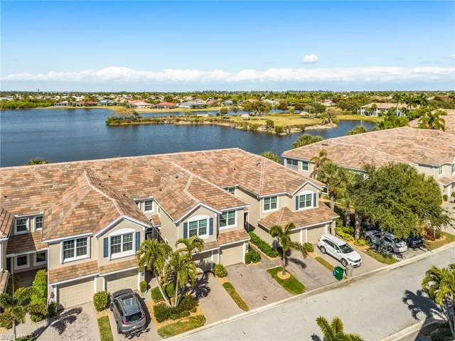 Aerial perspective of suburban area featuring a large body of water