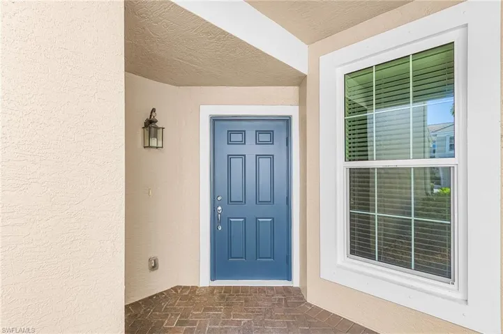 Entrance to property featuring stucco siding