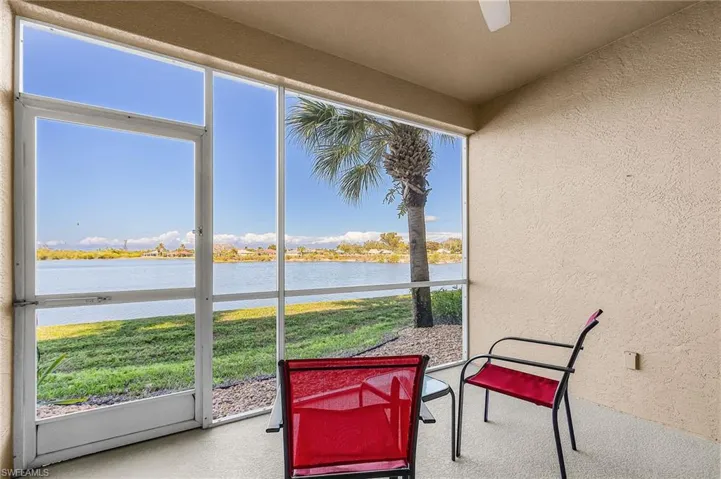 Sunroom with a water view and ceiling fan