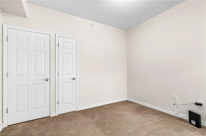 Unfurnished bedroom with baseboards and carpet flooring
