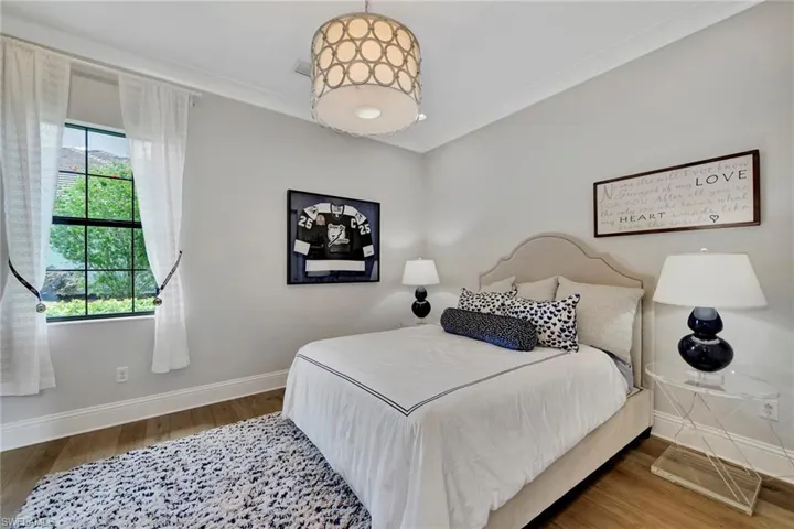Bedroom with wood-type flooring and ornamental molding