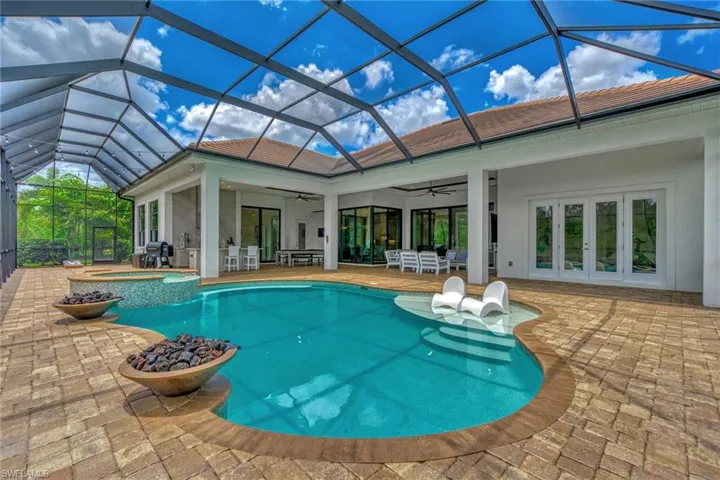 View of pool with a patio, french doors, an in ground hot tub, glass enclosure, and ceiling fan