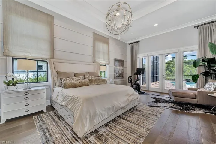 Bedroom featuring multiple windows, french doors, access to outside, and dark wood-type flooring