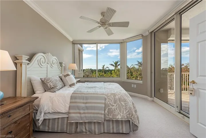 Bedroom featuring ceiling fan, ornamental molding, light carpet, and access to outside