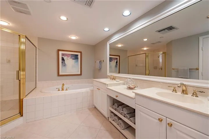 Bathroom featuring tile patterned flooring, vanity, and independent shower and bath