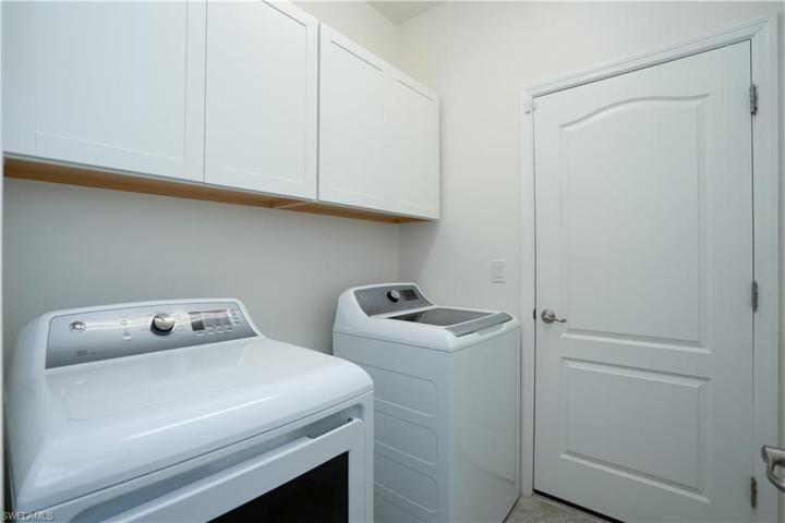Gas Dryer and Washing Machine with added cabinets for storage