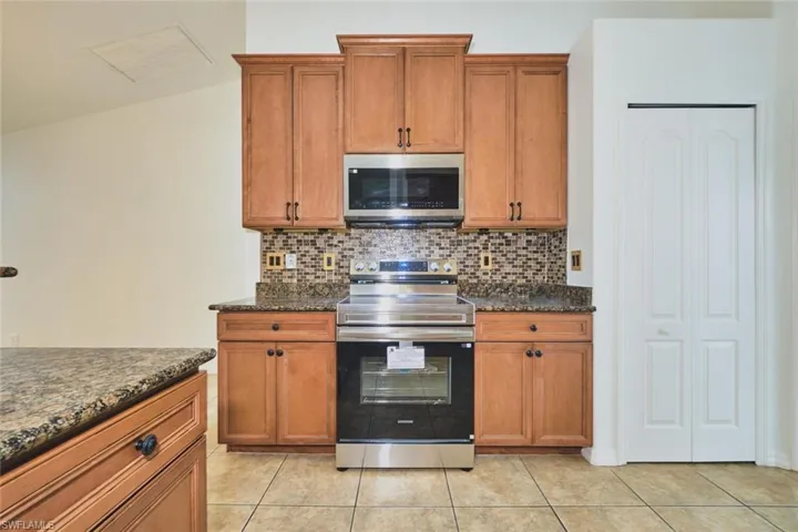 Kitchen with brown cabinets and stainless steel appliances