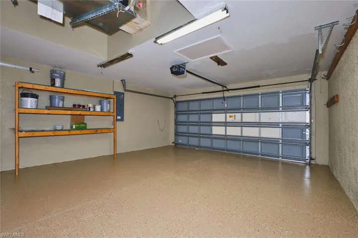Garage with electric panel and a garage door opener
