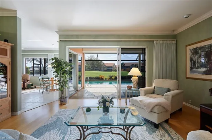 Living room featuring hardwood floors and sliders to lanai
