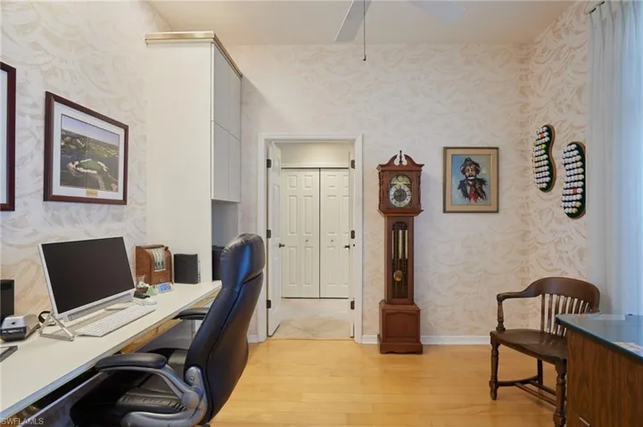 Home office with hardwood floors, built-in desk and storage