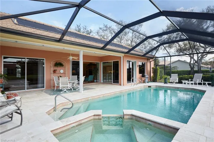 View of pool and spa looking toward the home...sliders and windows galore!