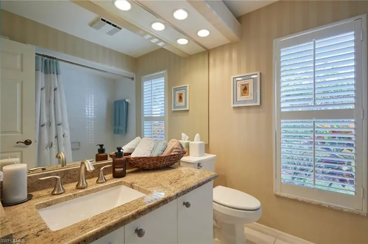 Full bath with granite countertops, tub/shower combo