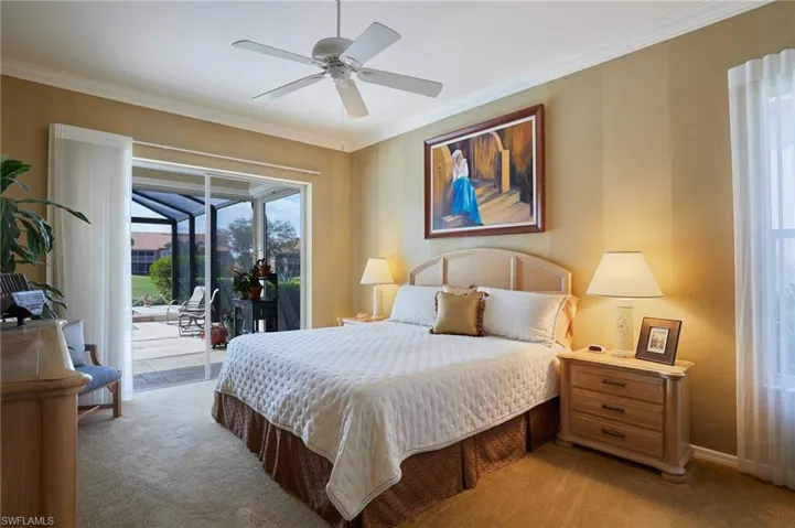 Bedroom featuring access to outside, crown molding, custom paint pattern