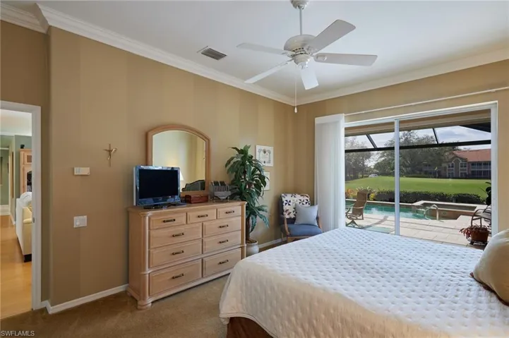 primary bedroom showing access to the pool area/lanai
