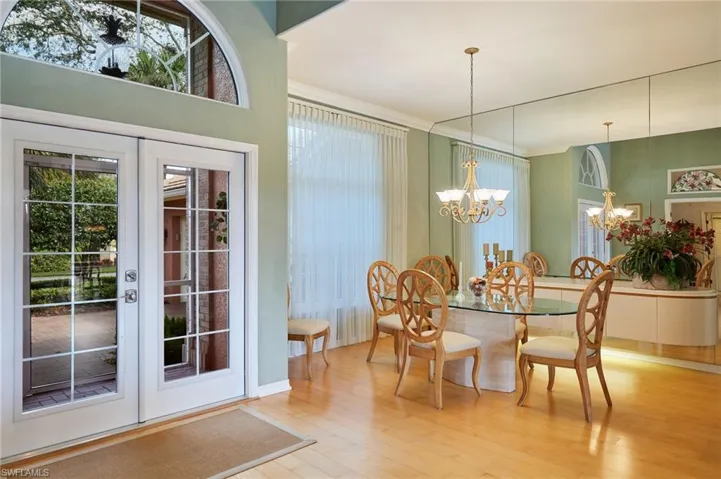 Dining room with hardwood floors and mirrored wall