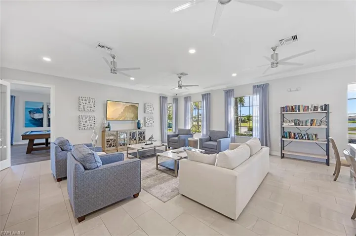 Living area with ornamental molding, billiards, and recessed lighting