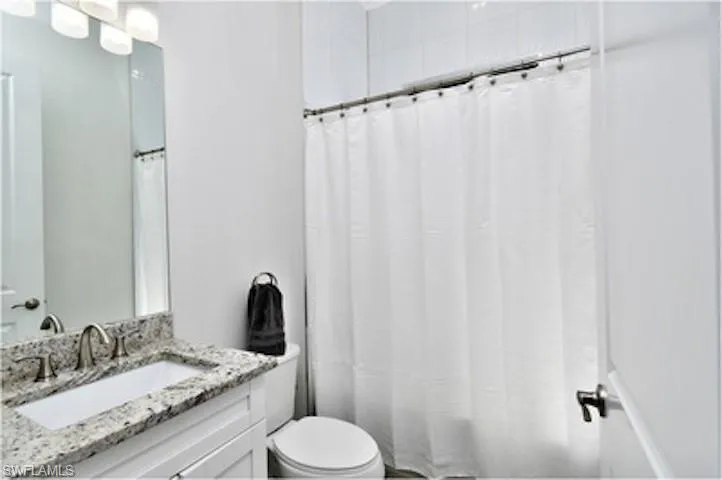 Bathroom with vanity and shower / bath combo with shower curtain