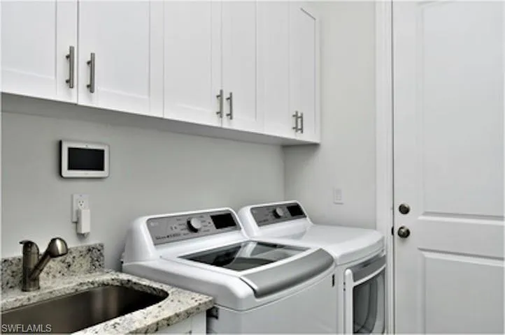 Laundry area with washing machine and dryer and cabinet space