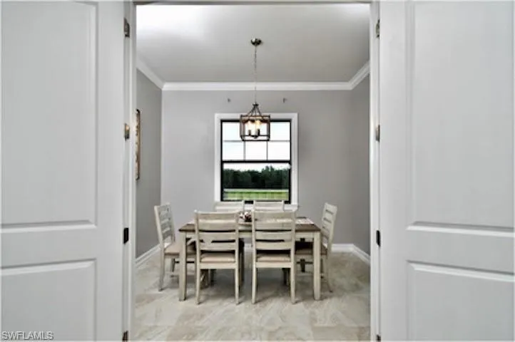 Dining space featuring ornamental molding and baseboards