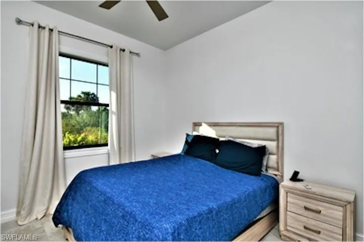 Bedroom with a ceiling fan and baseboards