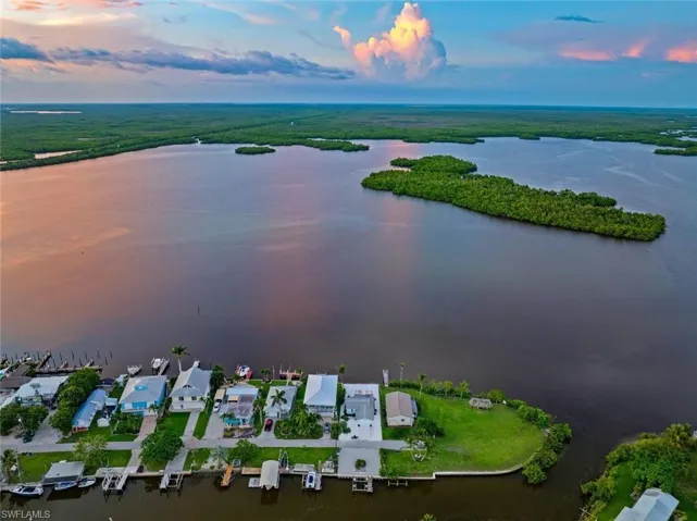 Aerial view of property and surrounding area featuring a large body of water