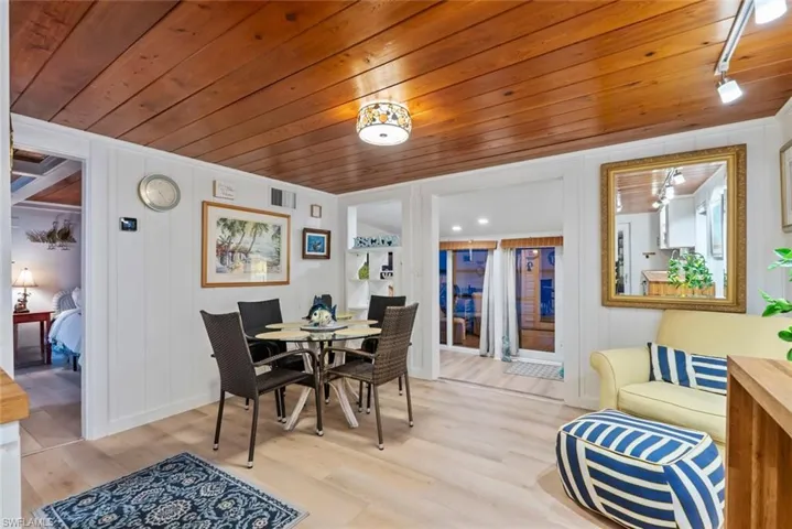 Dining area with light wood-style flooring and wooden ceiling