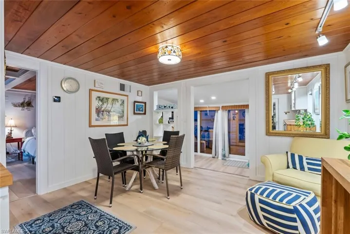 Dining space with light wood finished floors and wooden ceiling