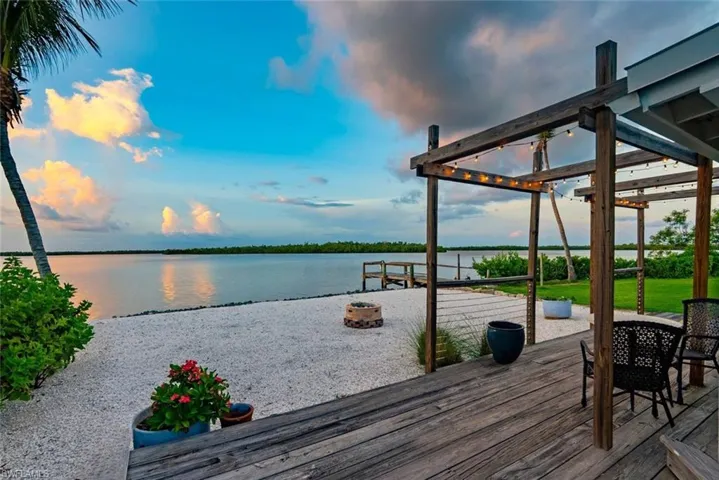 Dock area featuring a deck with water view and a pergola