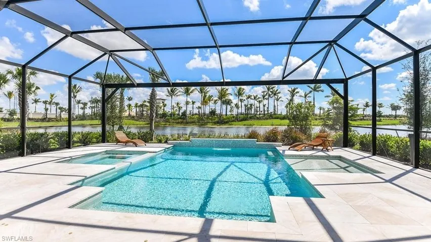 View of swimming pool featuring a water view, a patio, and glass enclosure