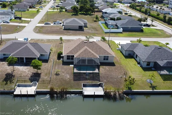 Aerial perspective of suburban area featuring a large body of water