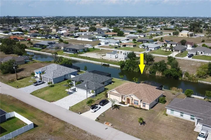Aerial perspective of suburban area with a large body of water