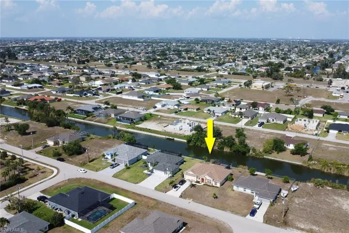 View of property location with a nearby body of water and nearby suburban area