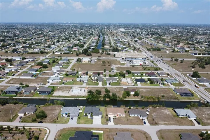 Aerial view of property's location with nearby suburban area
