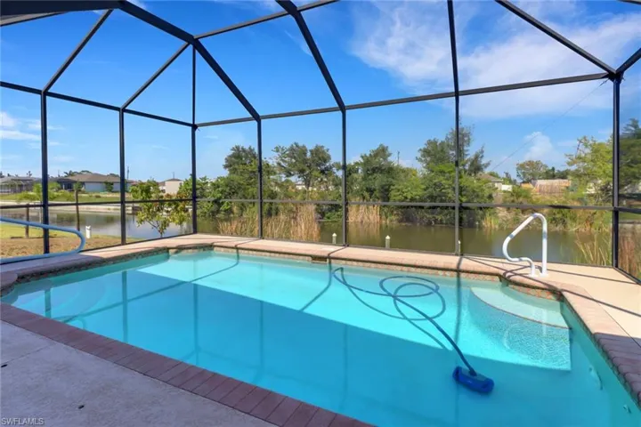 Outdoor pool with a water view, a lanai, and a patio area