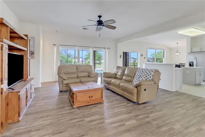 Living area featuring a ceiling fan and light wood finished floors