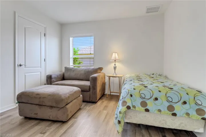 Bedroom featuring light wood-type flooring and baseboards
