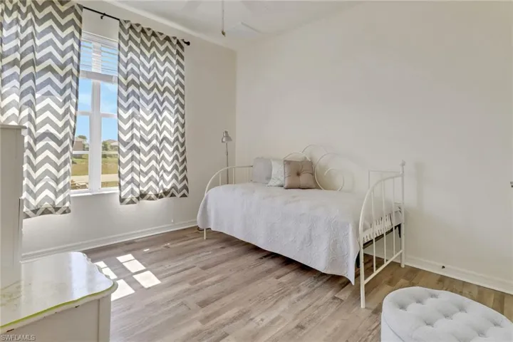 Bedroom with light wood-style floors and a ceiling fan